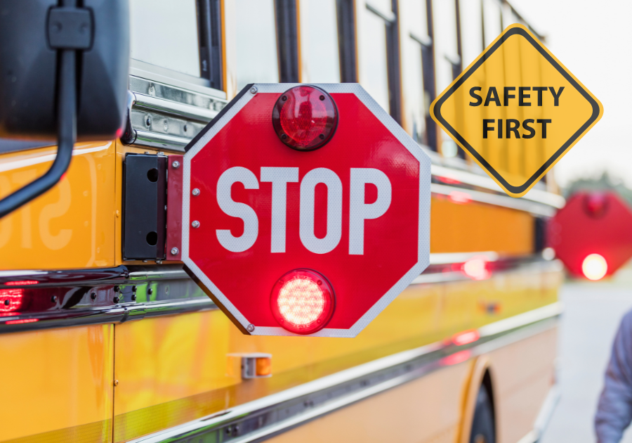 a stop sign swings out from the side of a school bus